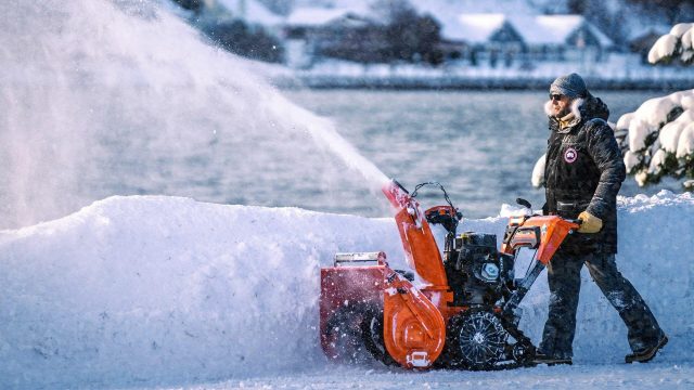 Bilde av en person som bruker en Ariens snøfreser til å rydde bort snø.